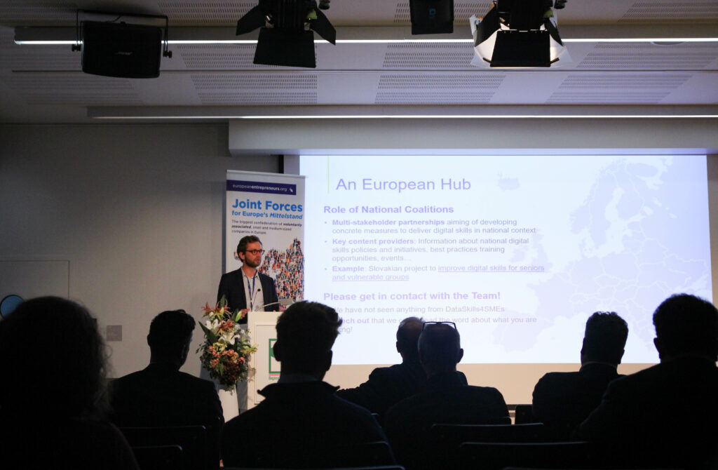 Photo of a person speaking to an audience of experienced European entrepreneurs and stakeholders