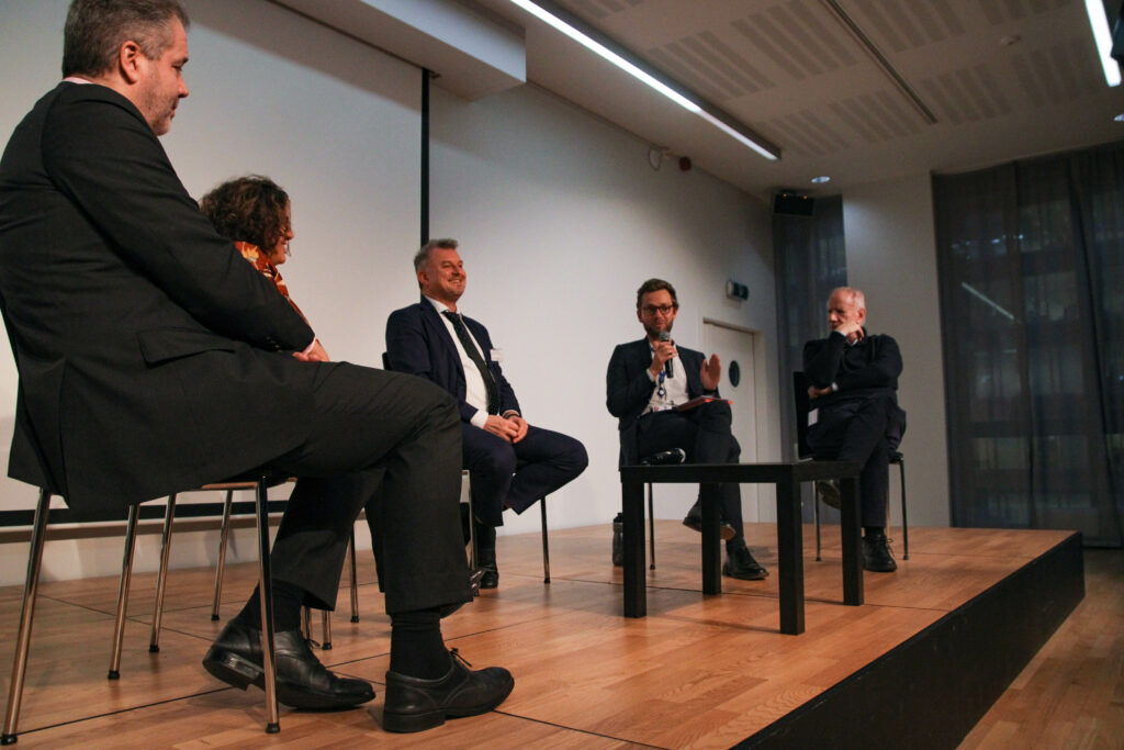 A photo of a panel of 5 participants, discussing the need for training and learning digital skills and new opportunities